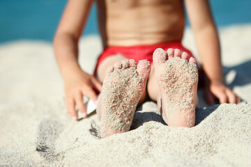 A feet of a happy child near the seashore in nature weekend travel