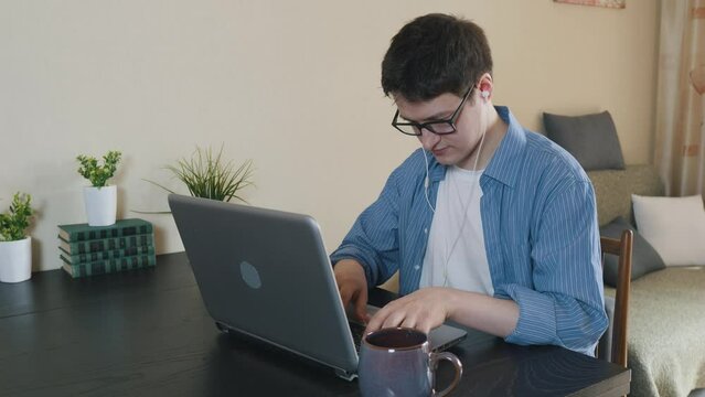 Young man male freelancer working home using laptop.