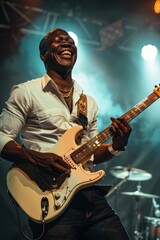 A man performing on stage with a white guitar. Great for music events promotion