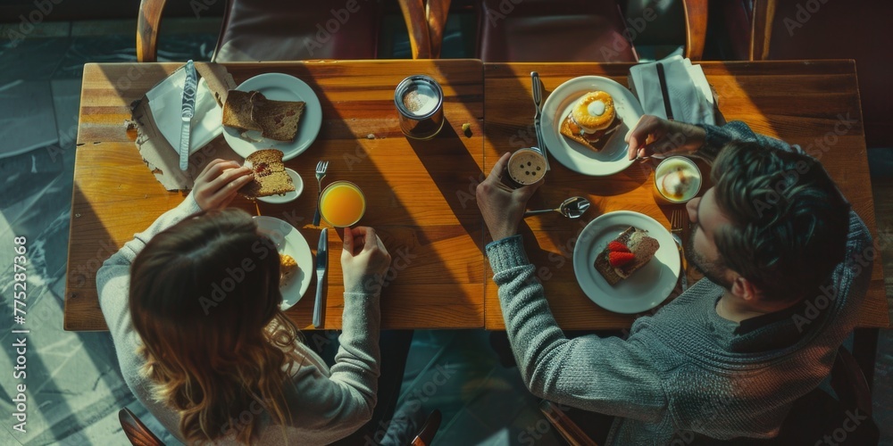 Poster two people sitting at a table with plates of food. suitable for restaurant or food-related concepts