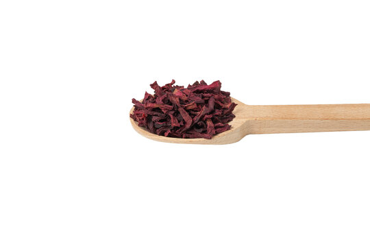 Dried beetroot slices on wooden spoon isolated on white background.