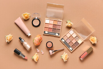 Makeup products with earrings and roses on brown background