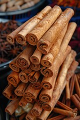 A pile of cinnamon sticks on a wooden table. Perfect for food and kitchen themes