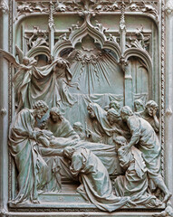 MILAN, ITALY - SEPTEMBER 16, 2024: The detail from main bronze gate of the Cathedral -   Dormition of Virgin Mary -  by Ludovico Pogliaghi (1906). - 775307389