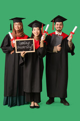 Graduate students holding diplomas and chalkboard with text GOODBYE UNIVERSITY on green background