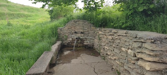 spring water flows from the pipe. High quality photo