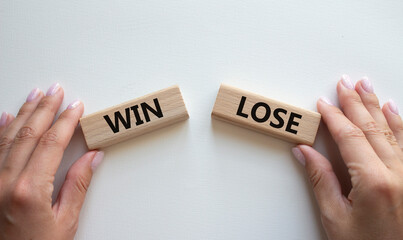 Win or Lose symbol. Concept word Win or Lose on wooden blocks. Businessman hand. Beautiful white background. Business and Win or Lose concept. Copy space