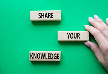 Share your knowledge symbol. Concept word Share your knowledge on wooden blocks. Businessman hand. Beautiful green background. Business and Share your knowledge concept. Copy space