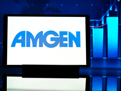 In this photo illustration,  Amgen Inc. (formerly Applied Molecular Genetics Inc.)  logo seen displayed on a tablet