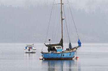 Boats in front of the shore of Cowichan Bay during a winter season on Vancouver Island in British Columbia, Canada