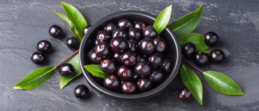   A bowl of black olives on a slate background with copy space for text or an image
