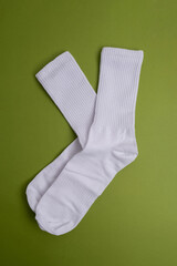 Pair of white socks on a colored background, flat lay. Place for text. Women's and men's socks