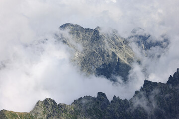 Slovak Tatra Mountains in the clouds on a sunny day in summer.