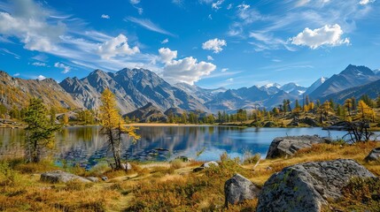 A wide view of a mountain lake with a backdrop of mountain ranges, in a national park located in the Altai Republic, Siberia, Russia.