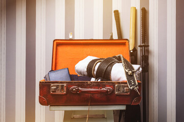 An open travel suitcase of a martial artist in the morning sun before traveling.