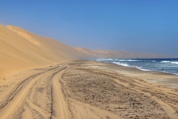 Fototapeta na wymiar Picture of the beach of the dunes of Sandwich Harbor in namibia tgas over at low tide