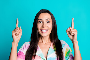 Photo of nice lady point fingers up empty space wear shirt isolated on turquoise color background