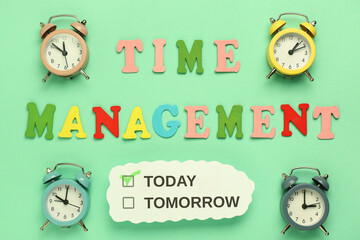 Text TIME MANAGEMENT with alarm clocks on green background. Top view