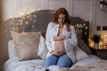 Beautiful redhead middle age pregnant woman expecting a baby