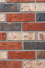 Brick wall with red and brown bricks, full frame background.