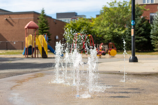 Splash pad playground in public park in summer without people.