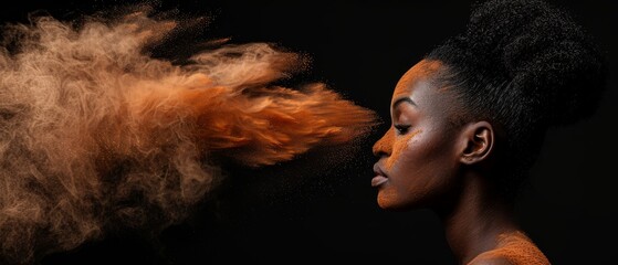   A woman with orange powder on her face and blowing hair in front of a black background