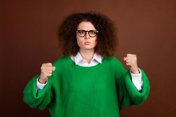 Photo of negative unsatisfied lady sullen face raise arms fists fight isolated on brown color...