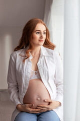 Beautiful redhead middle age pregnant woman expecting a baby
