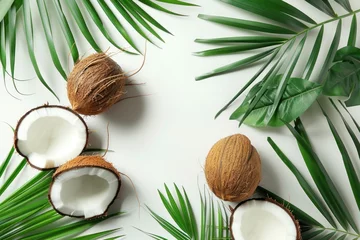 Fotobehang open coconuts with palm leaves on white background © Anna
