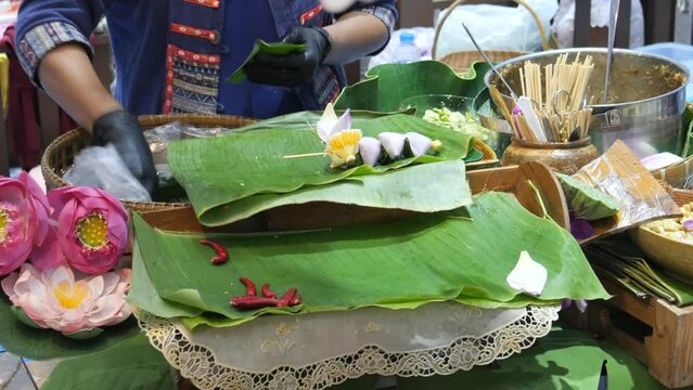 Making Miang Kham (traditional Southeast Asian herbal snack from Thailand and Laos), Traditional Thai snack. It&rsquo;s a snack containing different ingredients of herbs and vegetables. 