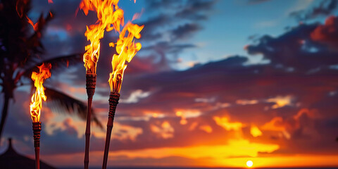 Hawaii luau party Maui fire tiki torches with open flames burning at sunset sky clouds at night - obrazy, fototapety, plakaty