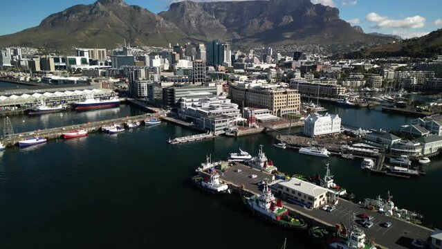 Cape Town, South Africa - April 2, 2024: Aerial drone view of Bustling Victoria and Alfred Waterfront in Cape Town, South Africa on a Clear Day with Table Mountain and CBD Cape Town in background