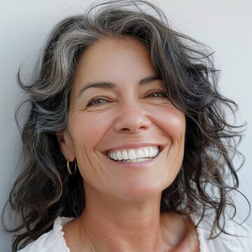 close up portrait of a beautiful 52 years old woman on a white background,