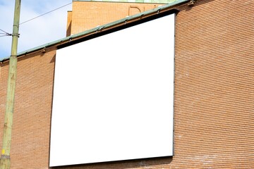 Large billboard on a brick wall.