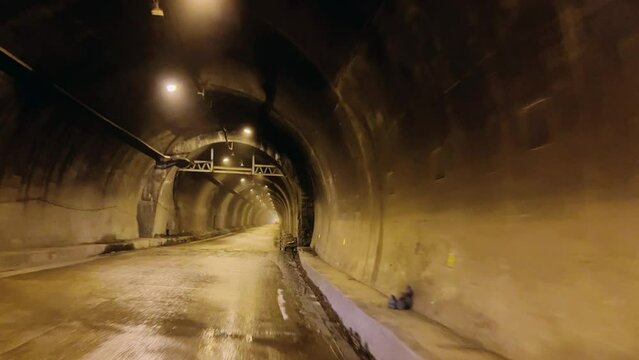 Tajikistan, June 5, 2023: A tunnel in a snowy mountainous area in Central Asia. The Anzob tunnel. Parts of the road to the Anzob pass through the Zarafshan mountain range. Tunnels in Tajikistan.