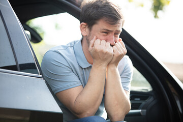 frustrated upset man after scratches on his car outdoors