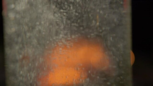 Super Slow Motion of Cachaça witn a bonfire in the background