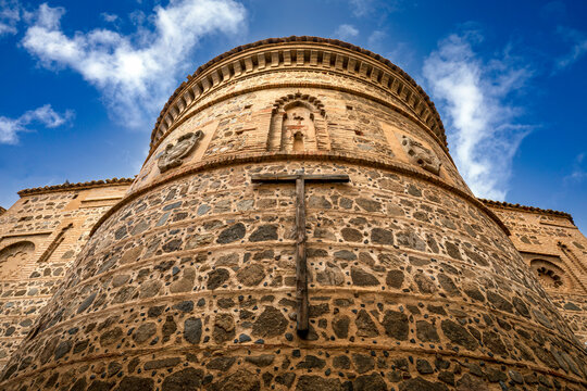 Apside of a medieval church with Moorish decoration in Toledo, Castilla la Mancha, Spain with a wooden Christian cross in the foreground