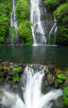 The dynamic flow of a jungle waterfall surrounded by verdant foliage, creating a serene sanctuary hidden away from the world