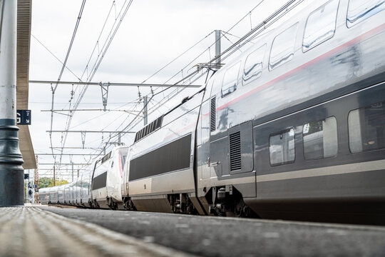 Ground-level view of a high-speed train at Dax station in France, highlighting the modernity and speed of European rail travel