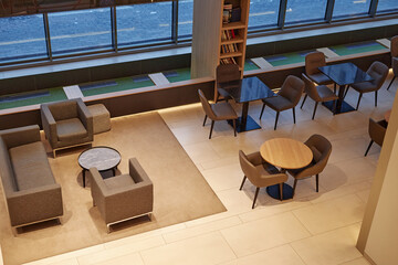 Top view wide angle of cafe or working area in hotel lobby with tables and seating no people