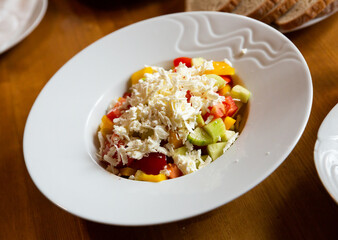 Shopska salad — dish of Balkan cuisine. Cucumbers, tomatoes, bell peppers and brynza (salted sheep cheese)