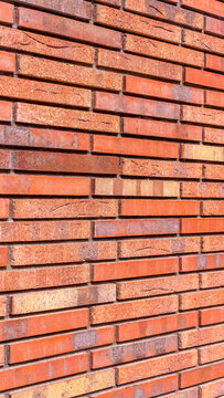 Red color brick wall for brickwork background design vertical photo