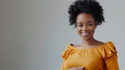 cheerful pregnant african american girl touching belly on grey  - obrazy, fototapety, plakaty