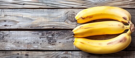   Three bananas on a wooden table with a wooden wall and wood background