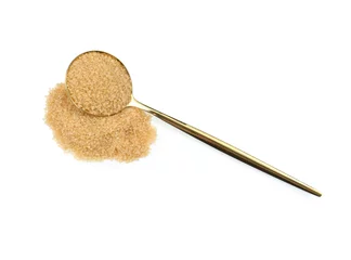 Poster Pile of brown sugar and spoon isolated on white, top view © New Africa