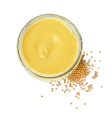 Poster Glass jar of tasty mustard sauce and dry seeds isolated on white, top view © New Africa