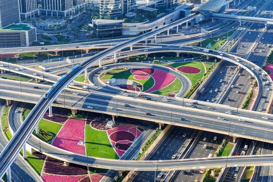 Intersection of Sheikh Zayed Road traffic on the road near the Burj Khalifa with Metro in Dubai, United Arab Emirates, Asia