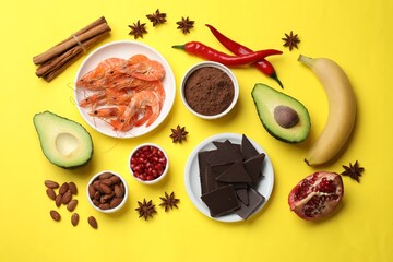 Natural aphrodisiac. Different food products on yellow background, flat lay