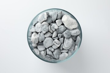 Presentation for product. Glass container with stones on light grey background, top view